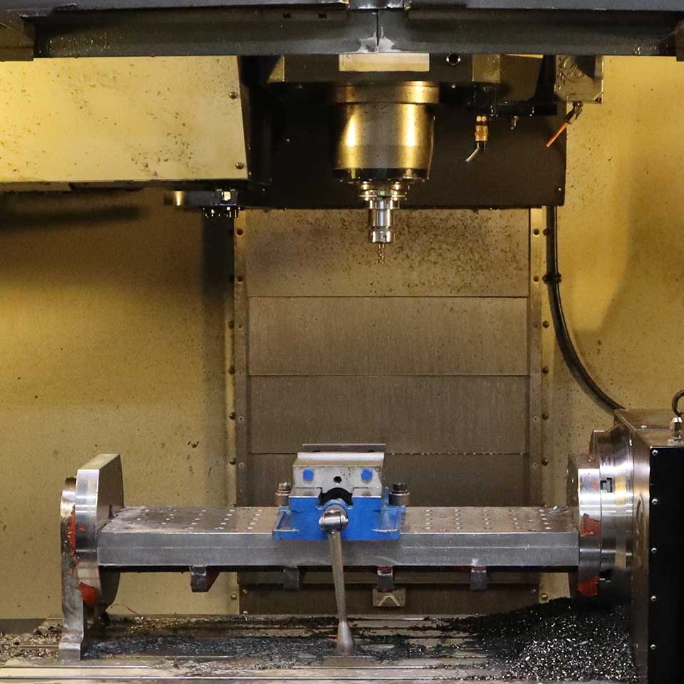 4 Axis Vertical Mill at West Point Industries that allows cutting to occur along all axes and vertical axis separately.